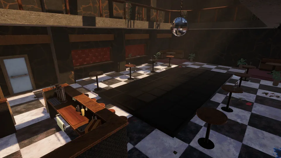 The empty dance floor by day, seen from behind the bar, with the mirror ball overhead.